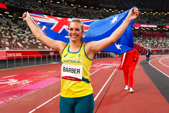 Kelsey-Lee Barber of Team Australia celebrates with the national flag after winning bronze in the women’s Javelin Final.