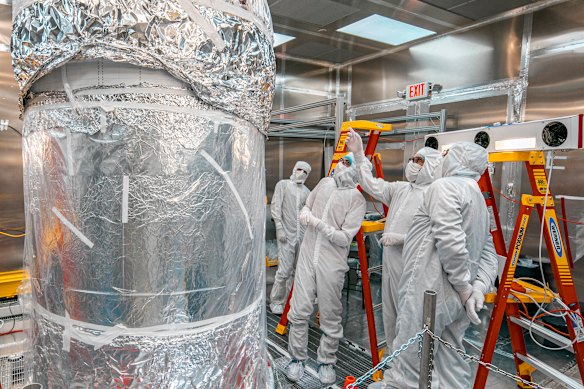 Researchers assess LZ’s central detector while it is wrapped in foil.