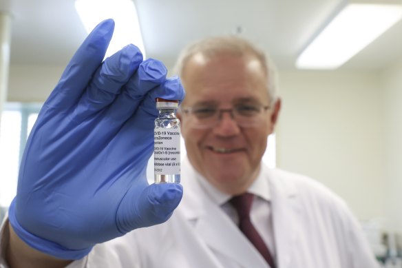 Prime Minister Scott Morrison holds up the AstraZeneca COVID-19 vaccine. 