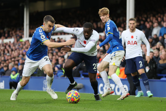 Tottenham’s Tanguy Ndombele is challenged by Seamus Coleman and Anthony Gordon of Everton.