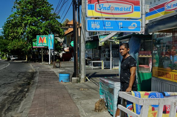 Erwin Manurung in front of his coconut stall in Kuta. 