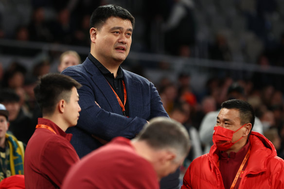 Standing out in the crowd: Yao Ming looks on at Tuesday night’s game.