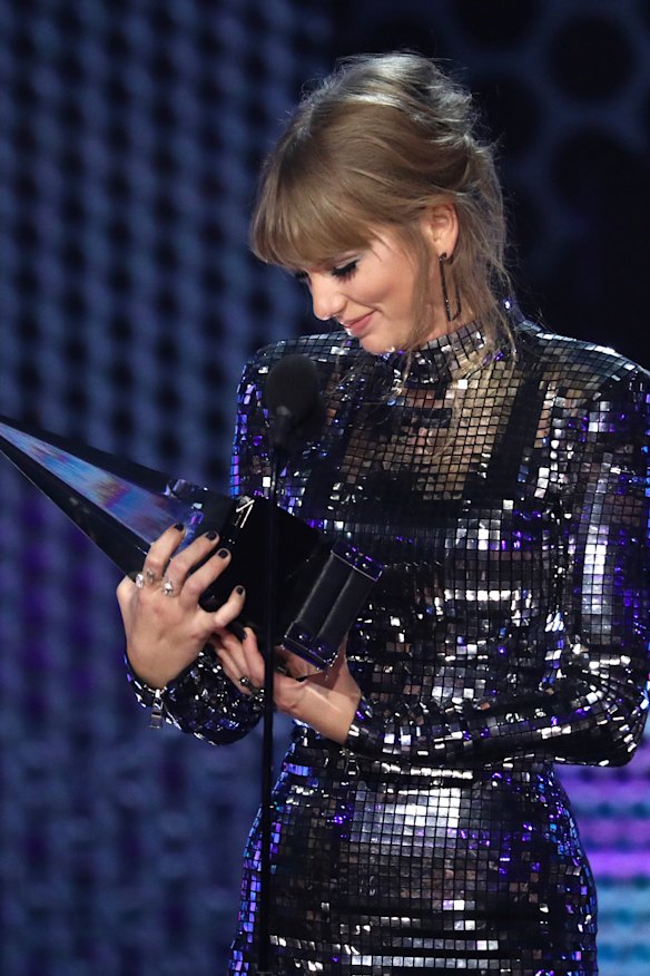 Taylor Swift accepts the award for artist of the year at the American Music Awards.