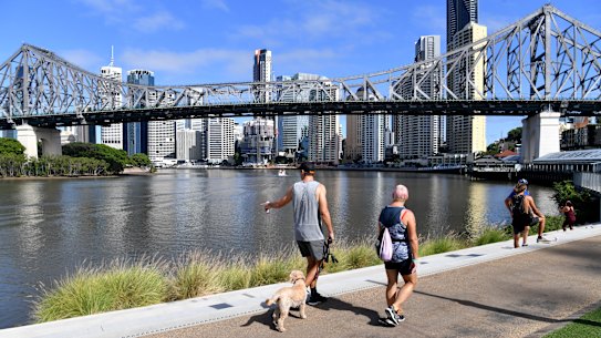 People are seen exercising along side the Brisbane River in Brisbane.