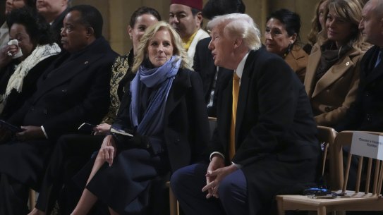 First Lady Jill Biden talks to President-elect Donald Trump sitting in Notre Dame Cathedral as France’s iconic cathedral formally reopened its doors 