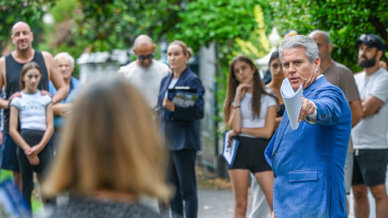 Auction crowd along with auctioneer at a house auction in Albert Park