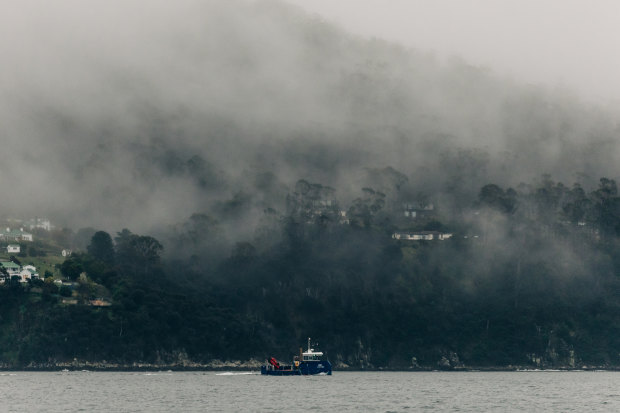 A Huon Aquaculture boat travels up the D’Entrecasteaux Channel, which locals say is polluted by effluent from fish farms.