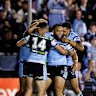 The Sharks celebrate a try.