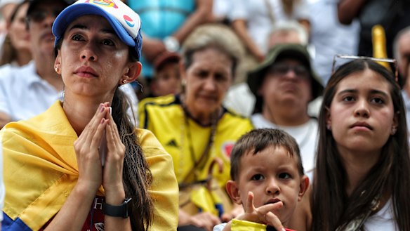Colombians gather to pray for Uribe Turbay on Sunday.