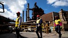 BlueScope employees walk past part of the blast furnace operating at Port Kembla. The plant, south of Sydney, is one of BlueScope’s largest.