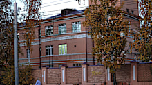 A woman with her child walks past the Irkutsk Anti-Plague Research Institute of Siberia and the Far East in Irkutsk, Russia, on Wednesday, October7.