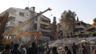 Emergency services work at a building hit by an air strike in Damascus blamed on Israel.