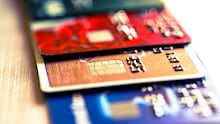 Close up macro color image depicting an abstract view of a collection of debit and credit cards and numeric digits. Room for copy space.