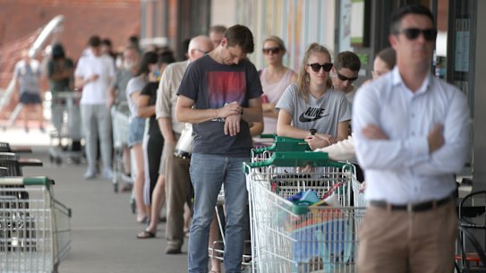 People queuing outside a Woolworths supermarket at West Torrens in Adelaide after the lockdown was announced.