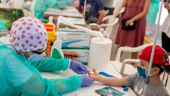 A child gets tested for COVID-19 in Torrejon de Ardoz, Spain.