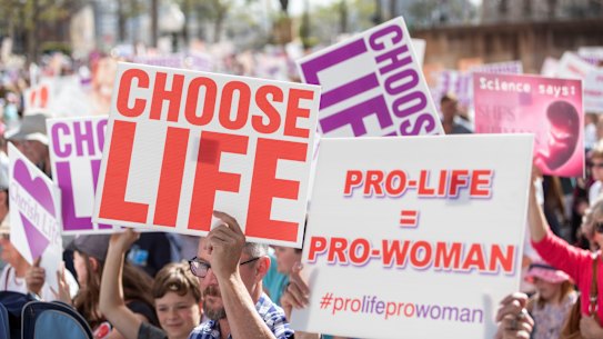 Protesters hold placards during a pro-life rally in Brisbane.