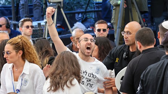 A man shouts as Israeli Prime Minister Benjamin Netanyahu speaks during a ceremony marking the Hebrew calendar anniversary of the Hamas attack on October 7 last year.