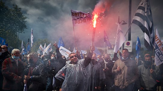 Raw emotions: Police officers demonstrate outside French Parliament.