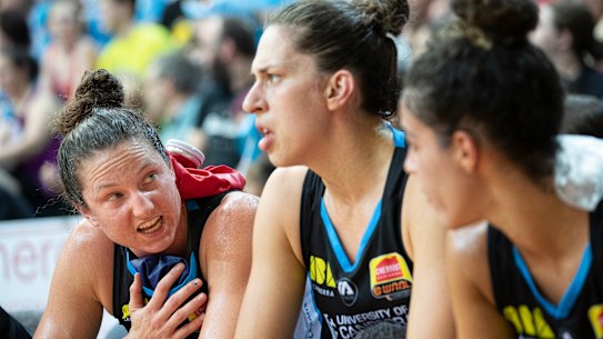 Capitals' Kelsey Griffin, Marianna Tolo, and Kia Nurse ice their shoulders on the bench. Photo: Sitthixay Ditthavong
