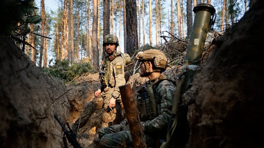 Ukrainian soldiers rest in a trench on the frontline near Kreminna, Luhansk region.