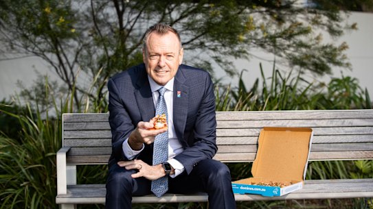 Domino’s pizza boss Don Meij tucks in.