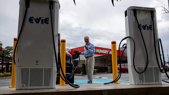 Evie Networks Chris Mills with an electric vehicle at the charging station at Macquarie shopping centre, Sydney