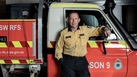 Former prime minister Tony Abbott pictured on Sunday in his role as a volunteer firefighter. 