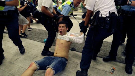 Police drag a protester away.