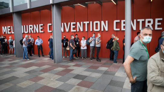 People line up for hotel quarantine training at Melbourne Convention Centre on Saturday.