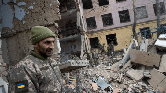 Military personnel on Tuesday, March 8, 2022, at a barracks used by Ukrainian airborne troops  that was attacked by Russian forces the day before in Mykolaiv, Ukraine.