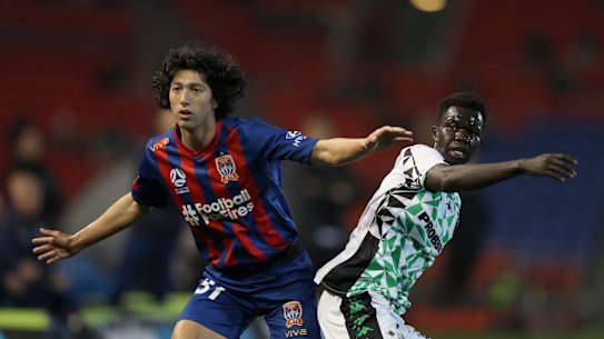 Newcastle's Maki Petratos and Western United's Valentino Yuel contest the ball in Sunday's clash at McDonald Jones Stadium.