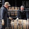 Workers load barrels of bourbon on to a truck at the Jim Beam Distillery in Clermont, Kentucky. 