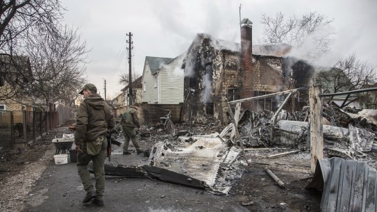 Ukrainian servicemen walk at fragments of a downed aircraft seen in in Kyiv, Ukraine.