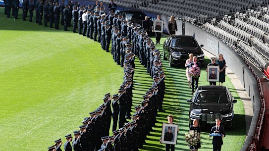 The guard of honour for the dead officers stretched around the boundary at Marvel Stadium