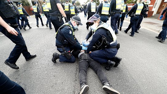 A man is arrested in Richmond, Melbourne, amid anti-lockdown protests.