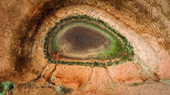 A windmill stands next to a dried-up dam on Australian farmer Ash Whitney’s drought-affected property located in the Goolhi area on the outskirts of Gunnedah, NSW, during the 2019 drought.