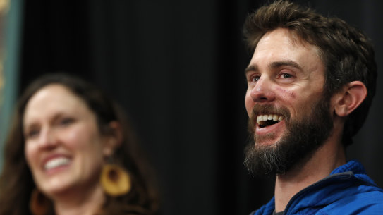 Runner Travis Kauffman, accompanied by his girlfriend Annie Bierbower, answers reporters' questions about his encounter with a mountain lion.