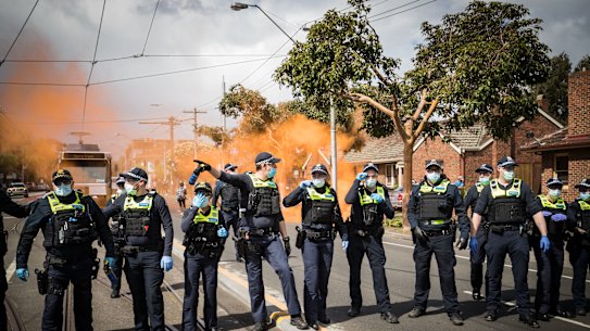 Members of Victoria Police block Bridge Road in Richmond on September 18.