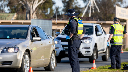 Victoria has shut the border to all of NSW and the ACT. Police, pictured here, stopping cars entering a checkpoint between Albury and Wodonga on Sunday. 