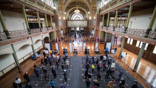 People wait to be vaccinated at Melbourne’s Royal Exhibition Building. 