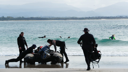 Police divers prepare to search water off Wategos Beach on Thursday. 