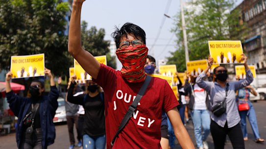Anti-coup protesters gesture during a march in Yangon, Myanmar. 