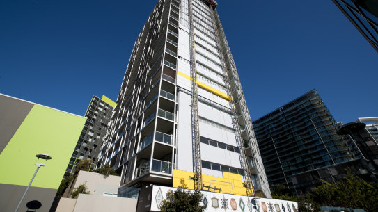 Cladding is removed from the Distillery apartment tower at Pyrmont in inner Sydney. 