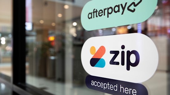 Shop window with signs of buy now, pay later providers. 