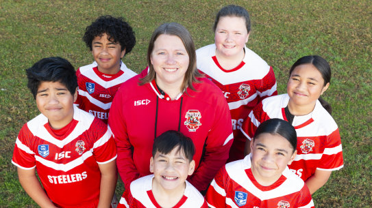 Doveton Steelers Rugby League Club Secretary Sheelagh Howarth standing on the field at Betulah Reserve, with junior players (far left, clockwise) Isaiah (8), Brooklyn (8), Evie (12), Lemafoe (9), Nani (9), and Campbell (8).