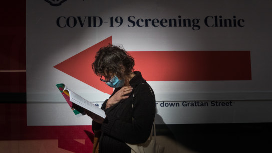 A woman waits outside a coronavirus testing station at Royal Melbourne Hospital on Thursday.