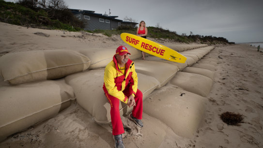 Inverloch Surf Lifesaving club President Warren Cook, pictured here with his daughter Jasmine. When the surf lifesaving club was built 10 years ago, it had no view of the sea but now the water is 30 metres from the door.