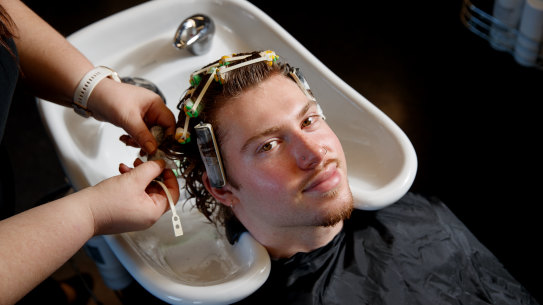 Lachlan Donnell gets a perm from TAFE teacher Suzanah Twist in Sydney.