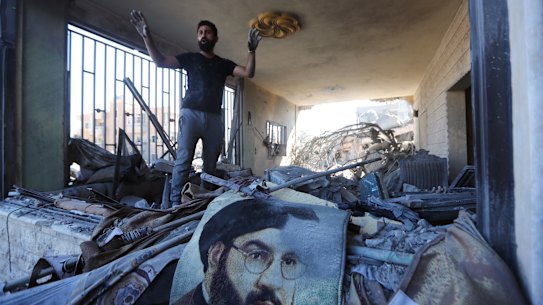 A man reacts in a damaged apartment at the site of an Israeli airstrike in Saksakieh, south Lebanon