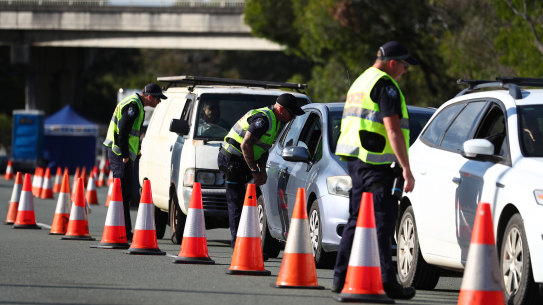 Police stop vehicles at the Queensland-NSW border in Coolangatta.